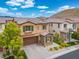 Attractive home featuring a well-manicured front yard, stone details, and a convenient two-car garage at 12240 Old Muirfield St, Las Vegas, NV 89141