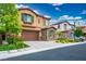 Two-story home with stone accents, tile roof, brown trim, well-manicured lawn, and a two-car garage at 12240 Old Muirfield St, Las Vegas, NV 89141