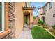 Inviting front entrance with a green door, stone accents, and a well-maintained walkway leading to the home at 12240 Old Muirfield St, Las Vegas, NV 89141