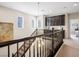 Upstairs hallway featuring custom built-in cabinets, dark wood banister, and neutral paint at 12240 Old Muirfield St, Las Vegas, NV 89141