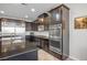 The kitchen features dark wood cabinetry, granite countertops, stainless steel appliances, and a large island with sink at 12240 Old Muirfield St, Las Vegas, NV 89141