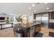 Spacious open-concept kitchen featuring a large island, stainless steel appliances, and seamless flow into the living area at 12240 Old Muirfield St, Las Vegas, NV 89141
