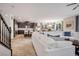 Open-concept living room featuring kitchen, dining room, and staircase at 12240 Old Muirfield St, Las Vegas, NV 89141