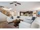 Open floorplan featuring a spacious living room, adjacent kitchen with a large island, and staircase at 12240 Old Muirfield St, Las Vegas, NV 89141