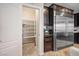 Walk-in pantry with bright lighting and white shelving for optimal kitchen storage solutions at 12240 Old Muirfield St, Las Vegas, NV 89141