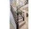 Elegant staircase with dark railing and carpeted steps, leading to the upper level of the home at 12240 Old Muirfield St, Las Vegas, NV 89141