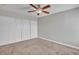 Bedroom featuring neutral carpet, ceiling fan, and closet at 1344 Lorilyn Ave # 3, Las Vegas, NV 89119