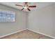 Cozy bedroom featuring a ceiling fan and plush carpeting at 1344 Lorilyn Ave # 3, Las Vegas, NV 89119