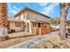 Tan two-story home featuring wooden fence and desert landscaping at 1344 Lorilyn Ave # 3, Las Vegas, NV 89119