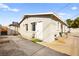 Home exterior featuring a basketball hoop, windows, door, and some chairs at 1516 Saylor Way, Las Vegas, NV 89108