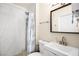 Bathroom featuring a shower with a tiled wall and a white sink at 1516 Saylor Way, Las Vegas, NV 89108