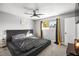 Bedroom featuring a large bed, ceiling fan, and a view to the outside at 1516 Saylor Way, Las Vegas, NV 89108