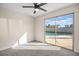 Bright bedroom featuring a ceiling fan and sliding glass doors to backyard pool at 1516 Saylor Way, Las Vegas, NV 89108