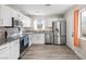 Renovated kitchen featuring stainless steel appliances, granite countertops, and white cabinetry at 1516 Saylor Way, Las Vegas, NV 89108