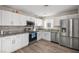 Bright kitchen featuring modern stainless steel appliances, granite countertops and white cabinetry at 1516 Saylor Way, Las Vegas, NV 89108