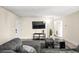 Living room featuring a large television, contemporary decor, and hardwood style floors at 1516 Saylor Way, Las Vegas, NV 89108