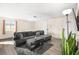 Cozy living room with wood flooring, a large sectional sofa, and natural light from the windows at 1516 Saylor Way, Las Vegas, NV 89108