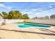 Backyard pool with concrete surround, privacy wall, and small grass lawn at 1516 Saylor Way, Las Vegas, NV 89108