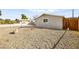 Exterior view of the side yard with gravel landscaping and a small side window at 1516 Saylor Way, Las Vegas, NV 89108