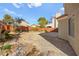 Spacious backyard featuring a hardscape area, rock garden, and a brick perimeter wall at 1904 Monte Alban Dr, North Las Vegas, NV 89031