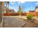 Spacious backyard with brick pavers, a low block wall and desert landscaping at 1904 Monte Alban Dr, North Las Vegas, NV 89031