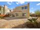 Desert landscaped backyard with tile roof, stucco walls, and patio area at 1904 Monte Alban Dr, North Las Vegas, NV 89031