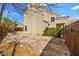 A view of the side and back of the home showing the stucco exterior and perimeter fencing at 1904 Monte Alban Dr, North Las Vegas, NV 89031