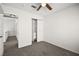 Empty bedroom featuring a ceiling fan, closet, and neutral decor, awaiting your personal touch at 1904 Monte Alban Dr, North Las Vegas, NV 89031