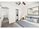 Cozy bedroom featuring a ceiling fan, closet, and neutral decor, virtually staged with bed and artwork at 1904 Monte Alban Dr, North Las Vegas, NV 89031