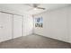 Well-lit bedroom featuring carpeted floors, closet, and a ceiling fan at 1904 Monte Alban Dr, North Las Vegas, NV 89031