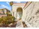 Inviting front entrance featuring lush shrubs and a charming courtyard leading to the front door at 1904 Monte Alban Dr, North Las Vegas, NV 89031