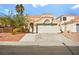 Charming single-story home featuring a tile roof, well-kept yard and an attached two-car garage at 1904 Monte Alban Dr, North Las Vegas, NV 89031