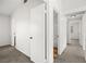 Hallway view featuring neutral-toned walls and carpet, with a view of a full bathroom and bedroom at 1904 Monte Alban Dr, North Las Vegas, NV 89031