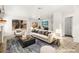 Staged living room featuring neutral tones, large windows, and stylish furniture, creating an inviting space at 1904 Monte Alban Dr, North Las Vegas, NV 89031