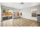 Bright living room featuring tile flooring, sliding glass door, and backyard view at 1904 Monte Alban Dr, North Las Vegas, NV 89031