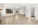 Open living area with neutral walls, tiled floors, ceiling fan, and bright windows at 1904 Monte Alban Dr, North Las Vegas, NV 89031