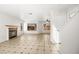 Open-concept living room showcasing stylish tile flooring, a cozy fireplace, and abundant natural light at 1904 Monte Alban Dr, North Las Vegas, NV 89031