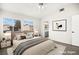 Bright main bedroom with a large window, ceiling fan and view into ensuite bathroom at 1904 Monte Alban Dr, North Las Vegas, NV 89031