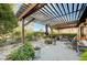 Cozy backyard patio with pergola, comfortable seating, and mature landscaping features at 1905 Calle De Espana, Las Vegas, NV 89102