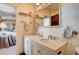 Charming bathroom with a vanity, decorative mirror, and an adjacent bedroom creates a harmonious flow at 1905 Calle De Espana, Las Vegas, NV 89102