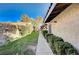 Side yard of a home, featuring manicured bushes, and partial lawn with privacy wall at 1905 Calle De Espana, Las Vegas, NV 89102