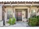 Charming front entrance with detailed stonework, beautiful greenery and a decorative door at 1905 Calle De Espana, Las Vegas, NV 89102