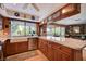 Eat-in kitchen has granite counters, wood cabinetry, and a farmhouse sink below a bright window at 1905 Calle De Espana, Las Vegas, NV 89102