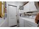 Laundry room with washer, dryer, storage cabinets and exterior door at 1905 Calle De Espana, Las Vegas, NV 89102