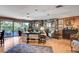 Cozy living room boasts a stone accent wall, hardwood floors, and lots of natural light from the sliding glass doors at 1905 Calle De Espana, Las Vegas, NV 89102