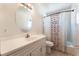 Bathroom with a vanity, oval mirror, and shower-tub combo at 212 Huntly Rd, Las Vegas, NV 89145