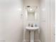 Clean powder room featuring pedestal sink, neutral walls, and modern fixtures at 212 Huntly Rd, Las Vegas, NV 89145