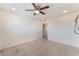 Empty bedroom with ceiling fan, carpet, and a doorway to hallway at 212 Huntly Rd, Las Vegas, NV 89145