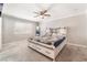 Cozy bedroom with a ceiling fan, natural light, and carpet flooring at 212 Huntly Rd, Las Vegas, NV 89145