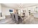 Dining area open to the kitchen with a large table and stylish chandelier at 212 Huntly Rd, Las Vegas, NV 89145